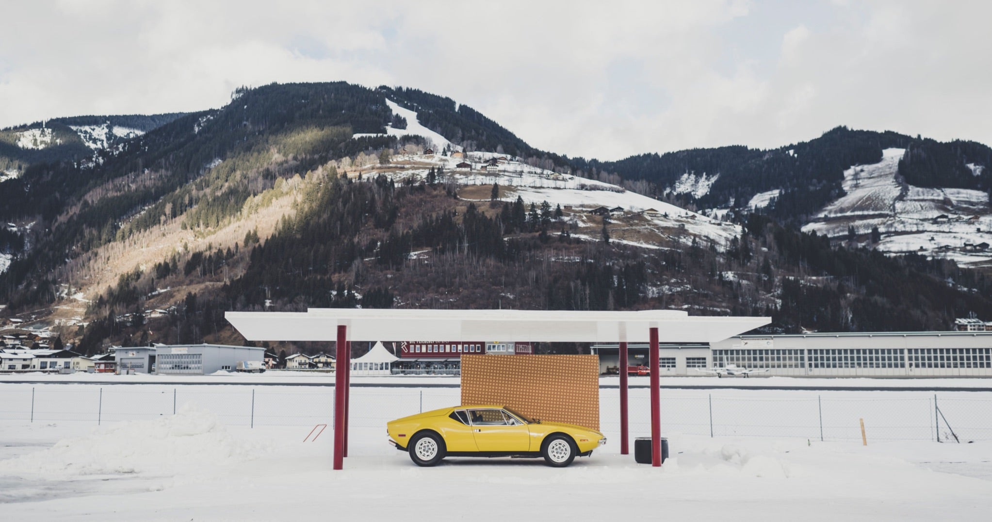 <span>A vintage yellow De Tomaso Pantera is displayed in a portable pavilion designed by Ferdi&rsquo;s firm, Steiner Architecture, for the 2022 GP Ice Race</span> <br/><span class="caption-sub"><em>Photo credit: Amy Shore </em></span><br/>
